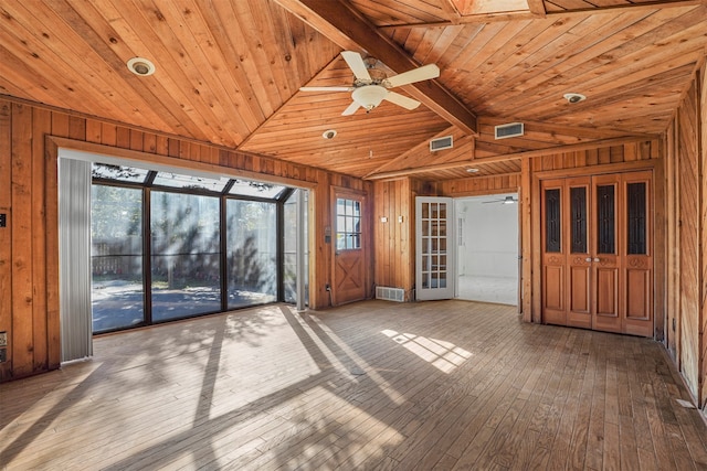 unfurnished living room featuring a wealth of natural light, wooden ceiling, and hardwood / wood-style flooring