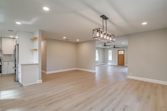 interior space featuring light wood-type flooring and ceiling fan