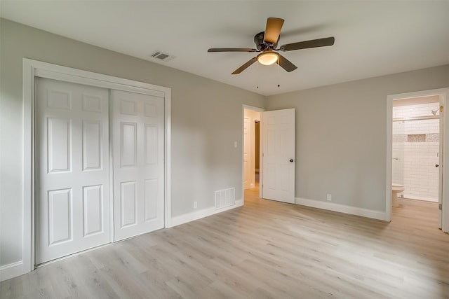 unfurnished bedroom featuring ceiling fan, a closet, ensuite bathroom, and light hardwood / wood-style flooring