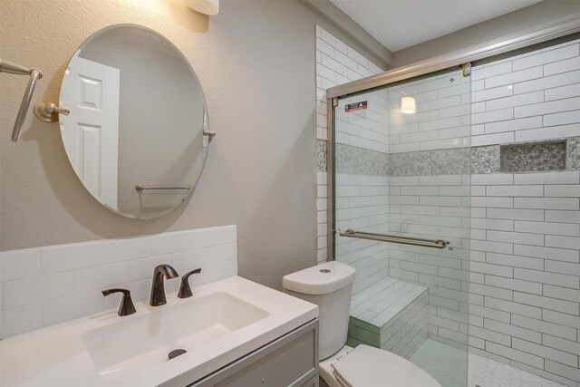 bathroom with vanity, toilet, and walk in shower