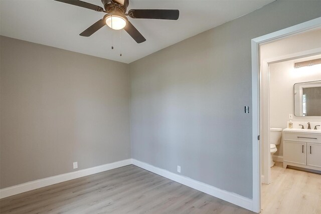 unfurnished room featuring light hardwood / wood-style flooring, ceiling fan, and sink