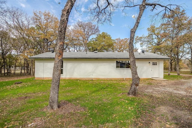 view of side of home with a lawn