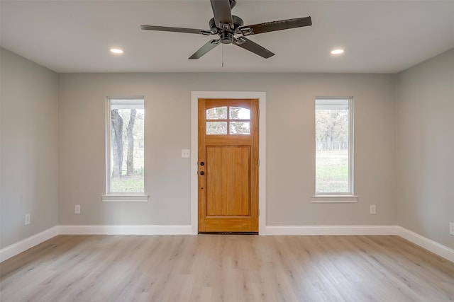 foyer entrance with light hardwood / wood-style floors and ceiling fan