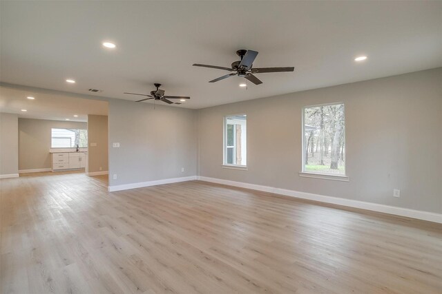 unfurnished room with ceiling fan and light hardwood / wood-style flooring