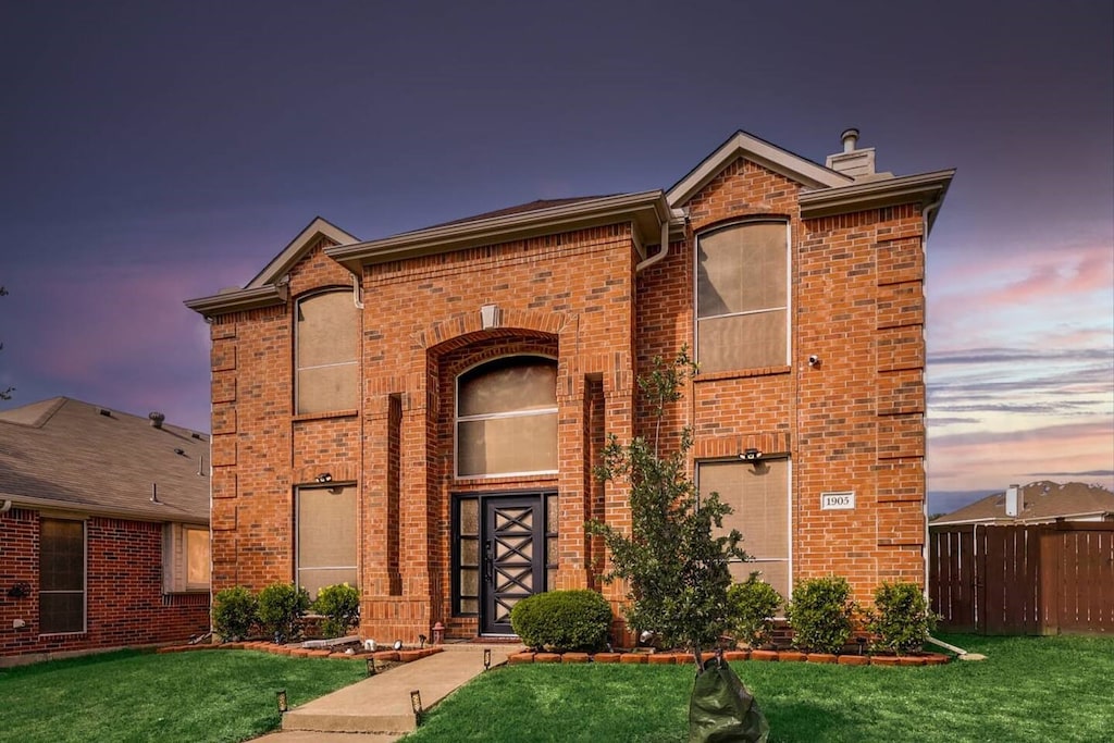 front facade with a yard