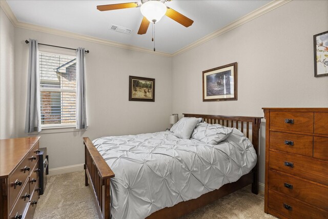 carpeted bedroom featuring ceiling fan and crown molding