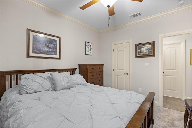 carpeted bedroom with ceiling fan, visible vents, and crown molding