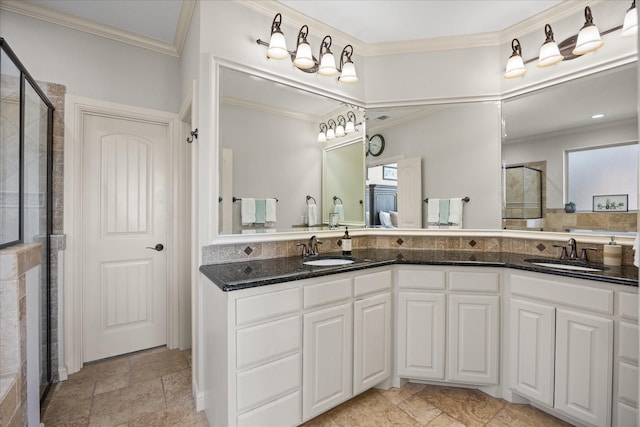 bathroom featuring double vanity, a stall shower, and a sink