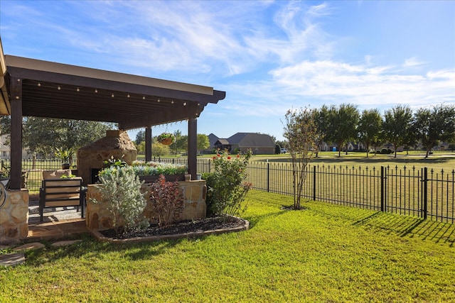 view of yard featuring fence and an outdoor fireplace