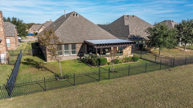 rear view of property with a lawn