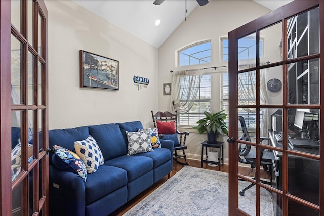 living room featuring high vaulted ceiling, french doors, wood finished floors, and a wealth of natural light