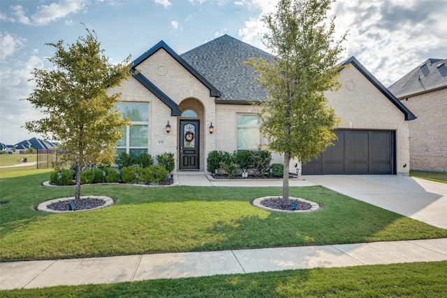 view of front facade with a garage and a front lawn