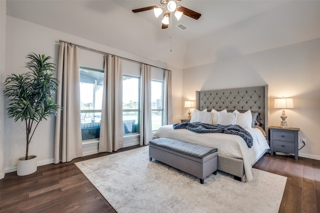 bedroom with dark hardwood / wood-style floors, vaulted ceiling, and ceiling fan