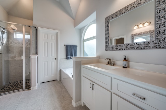 bathroom featuring tile patterned floors, vanity, separate shower and tub, and lofted ceiling