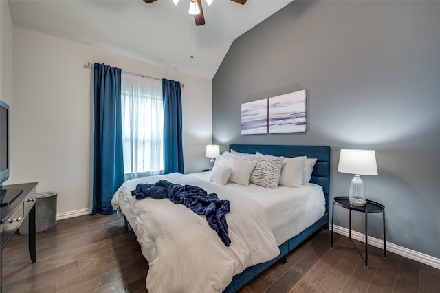 bedroom with ceiling fan, lofted ceiling, and dark wood-type flooring