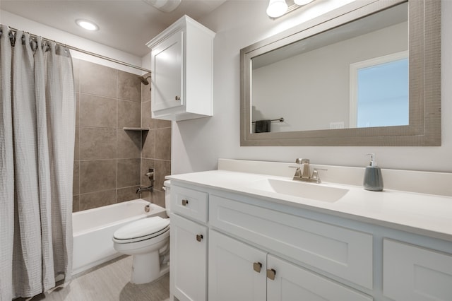 full bathroom featuring shower / bath combo with shower curtain, vanity, and toilet