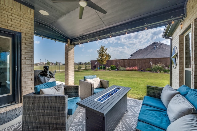 view of patio with ceiling fan and an outdoor fire pit