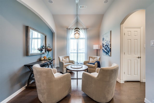 living area featuring dark hardwood / wood-style flooring and vaulted ceiling