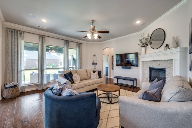 living room with crown molding, a fireplace, ceiling fan, and hardwood / wood-style flooring