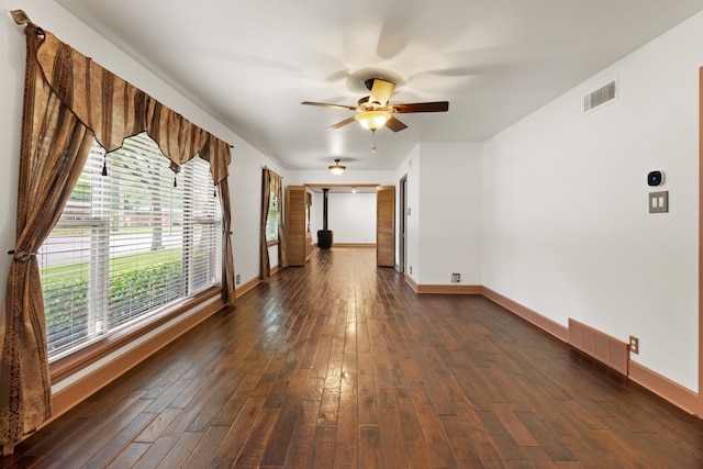 empty room with ceiling fan and dark wood-type flooring