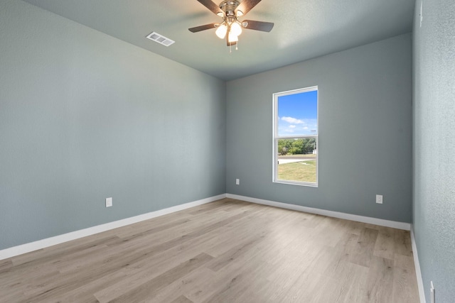 empty room featuring ceiling fan and light hardwood / wood-style floors