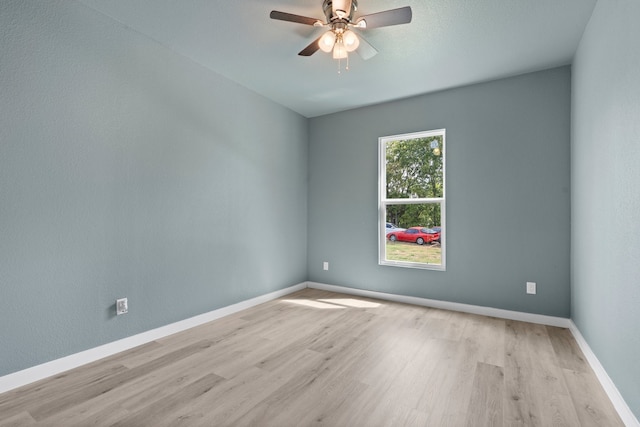 empty room with ceiling fan and light hardwood / wood-style floors