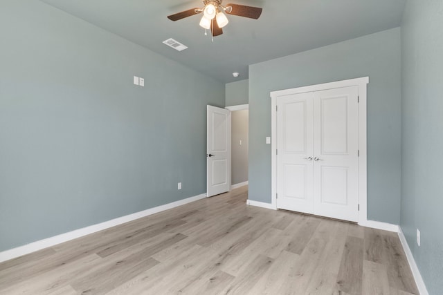 unfurnished bedroom featuring a closet, ceiling fan, and light hardwood / wood-style flooring