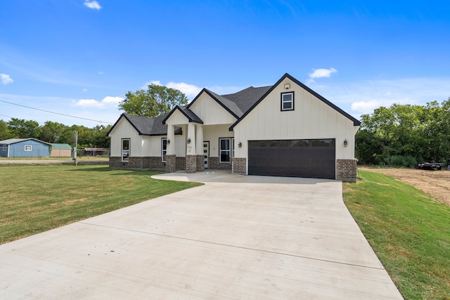 modern farmhouse with a front yard and a garage