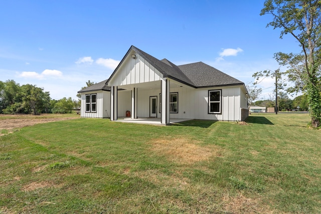 back of property with a patio and a lawn