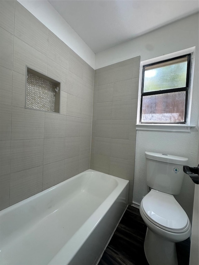 bathroom with hardwood / wood-style floors and toilet