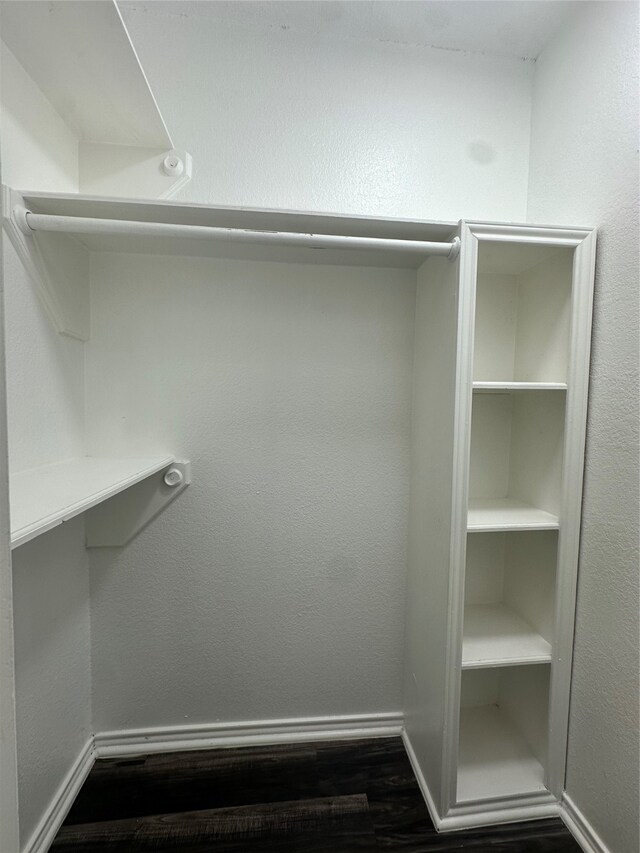 spacious closet featuring dark hardwood / wood-style floors