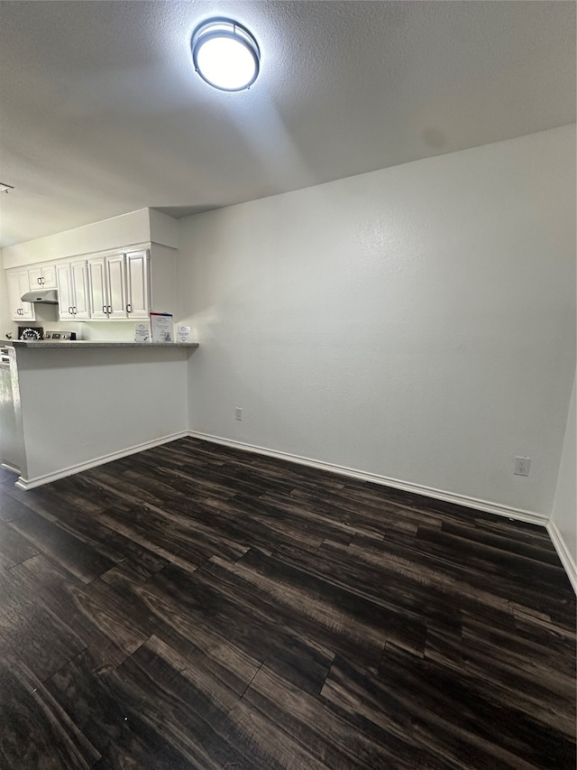 interior space featuring dark hardwood / wood-style flooring and a textured ceiling
