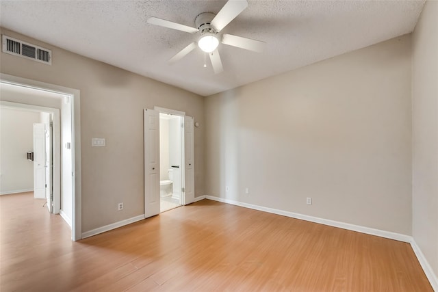 empty room featuring a textured ceiling, hardwood / wood-style flooring, and ceiling fan