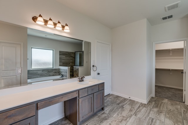 bathroom featuring vanity and separate shower and tub