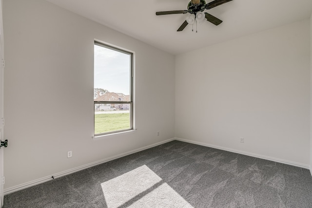 empty room featuring dark carpet and ceiling fan