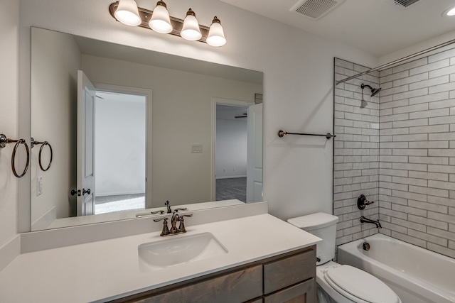 full bathroom with vanity, tiled shower / bath combo, and toilet