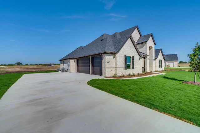 view of home's exterior featuring a lawn and a garage