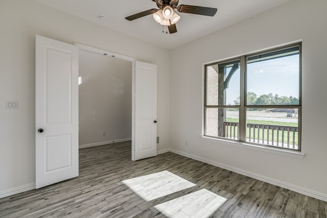 unfurnished bedroom featuring ceiling fan and light hardwood / wood-style floors