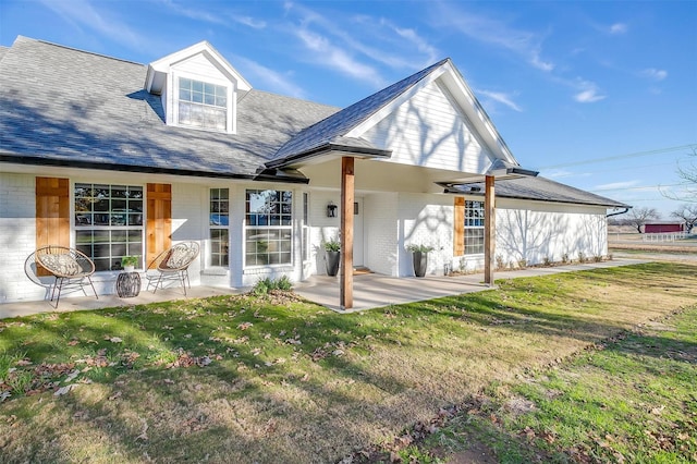 back of house with a yard and a patio area