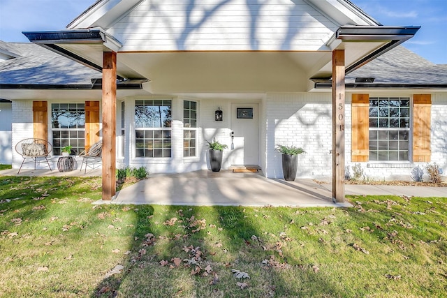 back of property with a patio area and a lawn