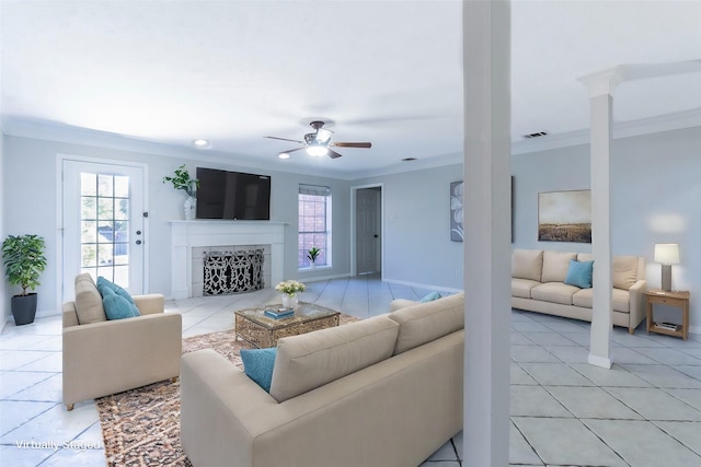 tiled living room with crown molding and ceiling fan