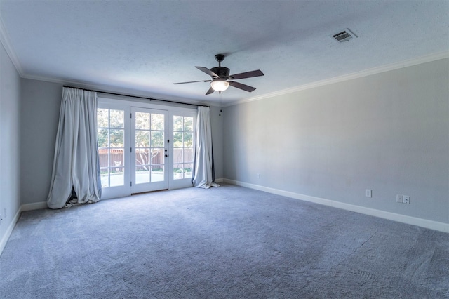 carpeted spare room with ceiling fan, crown molding, and a textured ceiling