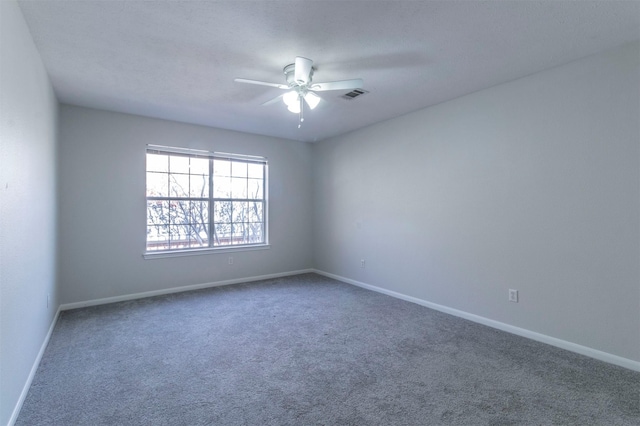 carpeted empty room featuring ceiling fan