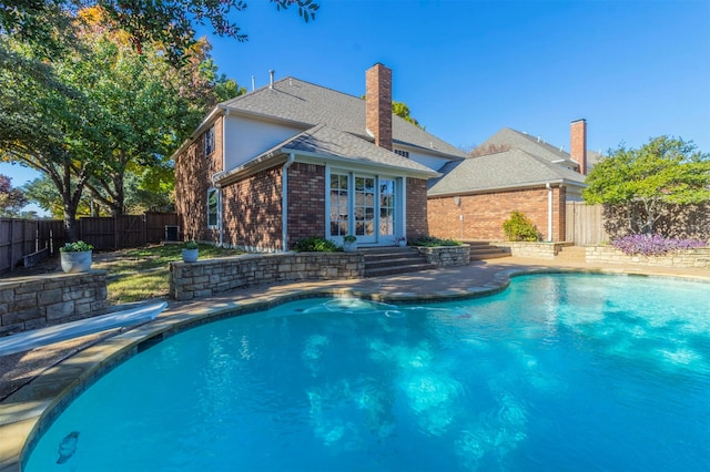 view of pool featuring french doors