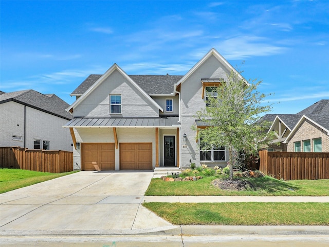 view of front of house featuring a front yard and a garage