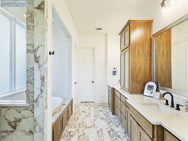 bathroom with a tub to relax in and vanity