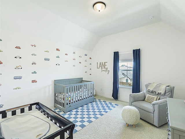 carpeted bedroom with lofted ceiling