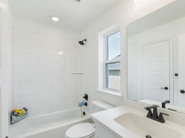 full bathroom with vanity, toilet, and tiled shower / bath