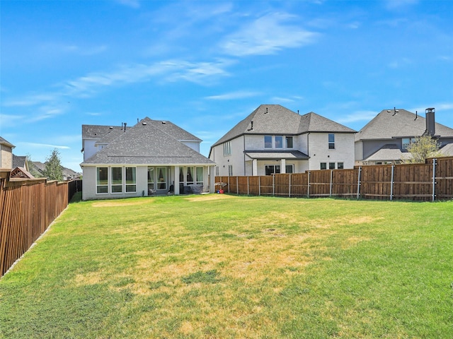 back of house featuring a yard