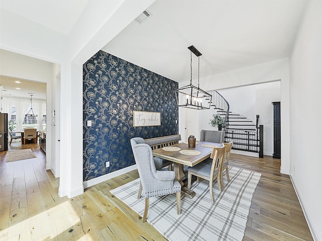 dining room featuring hardwood / wood-style flooring and a notable chandelier